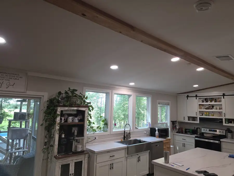 Farmhouse kitchen lit by recessed can lights