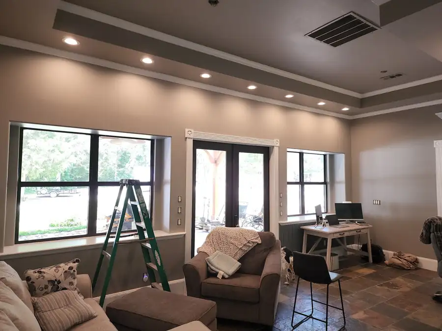 Living room tray ceiling with recessed lights, step ladder still in the room