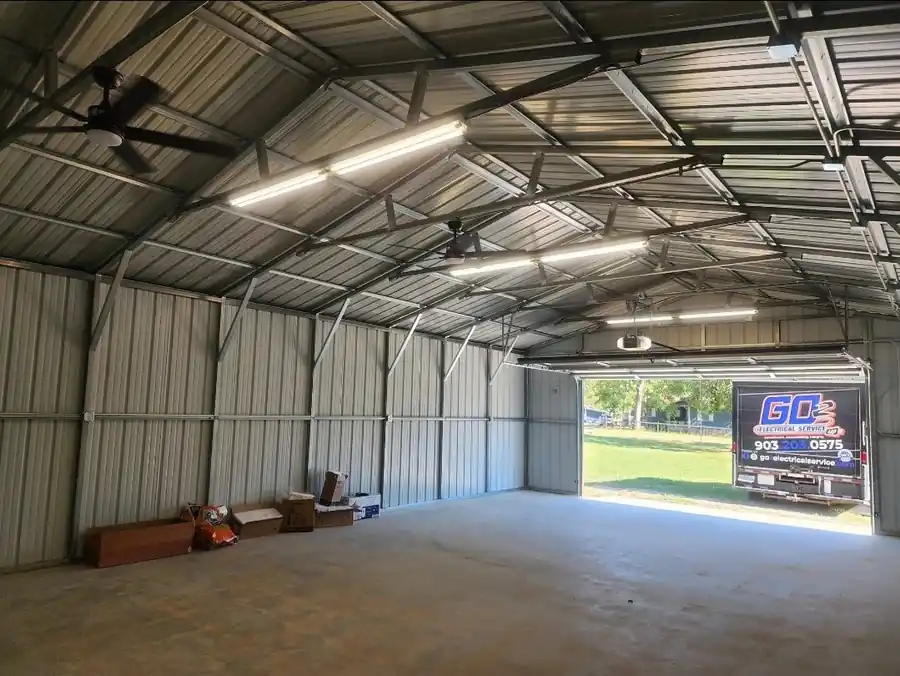Metal shop with LED strip lights and ceiling fans, the GO 2 truck in the open door